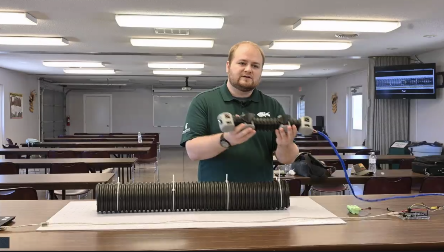 Christian Luedtke, a researcher at Michigan State University, demonstrates a prototype of a tile robot. (Screenshot from Iowa Learning Farms)