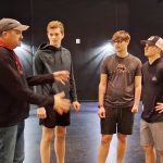 Director Dan Sarasio Meyer shows the boys how to fight during rehearsals for “The Outsiders,” including Ezra Thompson, Isaiah Mikes, and Luke Raulie.