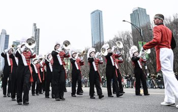 Drum major Cooper Blaser leads the brass section as the Forest City Marching Band performs in Chicago’s St. Patrick’s Day Parade. (Photo by Zach Raulie)