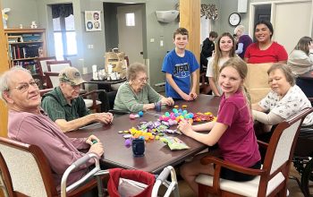 TAG students from North Iowa helped residents stuff Easter eggs for the Easter egg hunt on Saturday. Seated from left are: Kevin Stecker, Fred Fiebelkorn, Elaine Boehm, Fiona Potter, and Mary Mathews. Standing: Tate Paulsen, Peyton Paulsen, and Mayah Hullstrom.