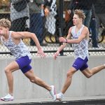 Nash Delger, right, hands off to Zach Stene as the Lake Mills Bulldogs took first place in the distance medley relay at Nevada. (Submitted photo)